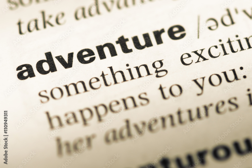 Close up of old English dictionary page with word adventure Close up of old English dictionary page with word adventure