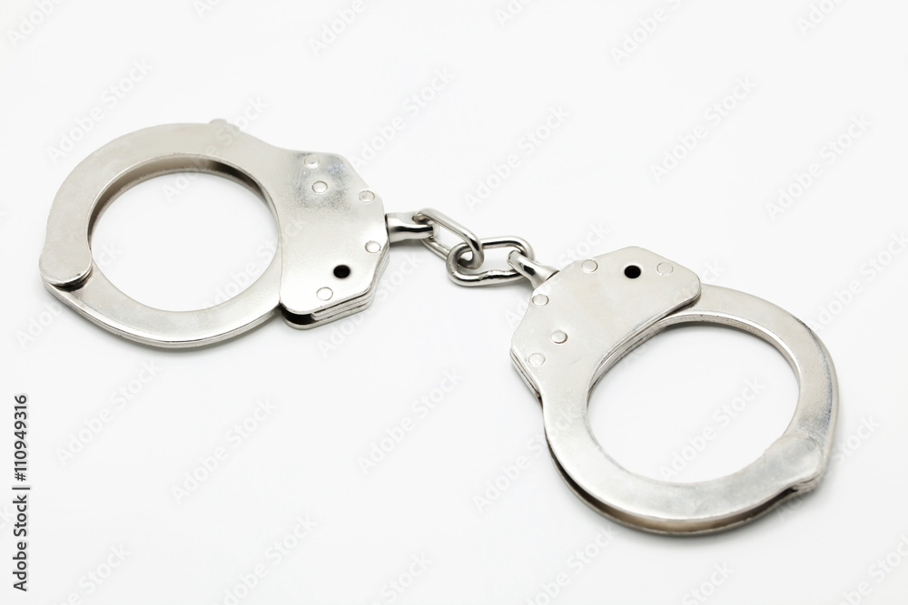 Closed Handcuffs on white isolated background Closed Handcuffs on white isolated background