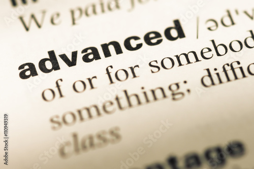 Close up of old English dictionary page with word advanced