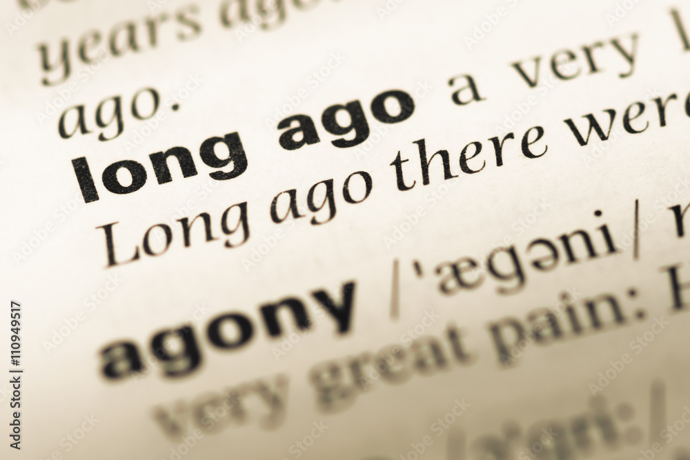 Close up of old English dictionary page with word long ago