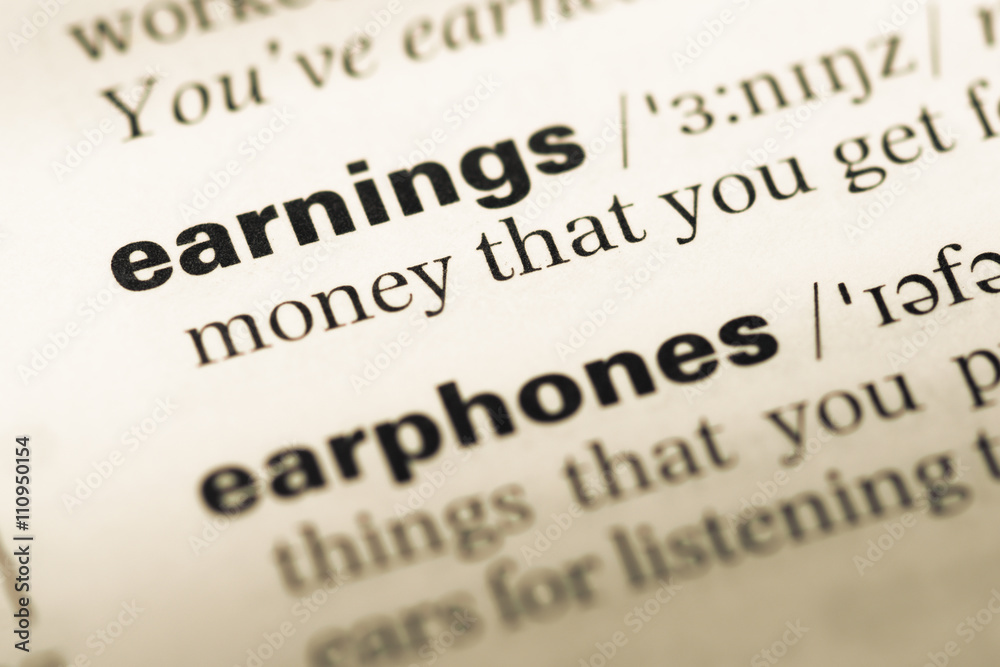 Close up of old English dictionary page with word earnings Close up of old English dictionary page with word earnings