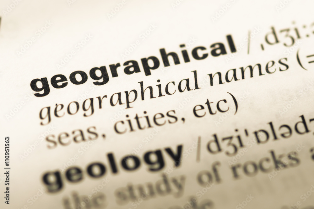 Close up of old English dictionary page with word geographical Close up of old English dictionary page with word geographical