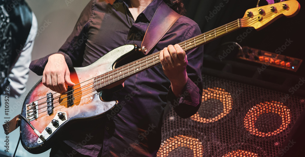 Fototapeta premium Rock music, bass guitar player on a stage