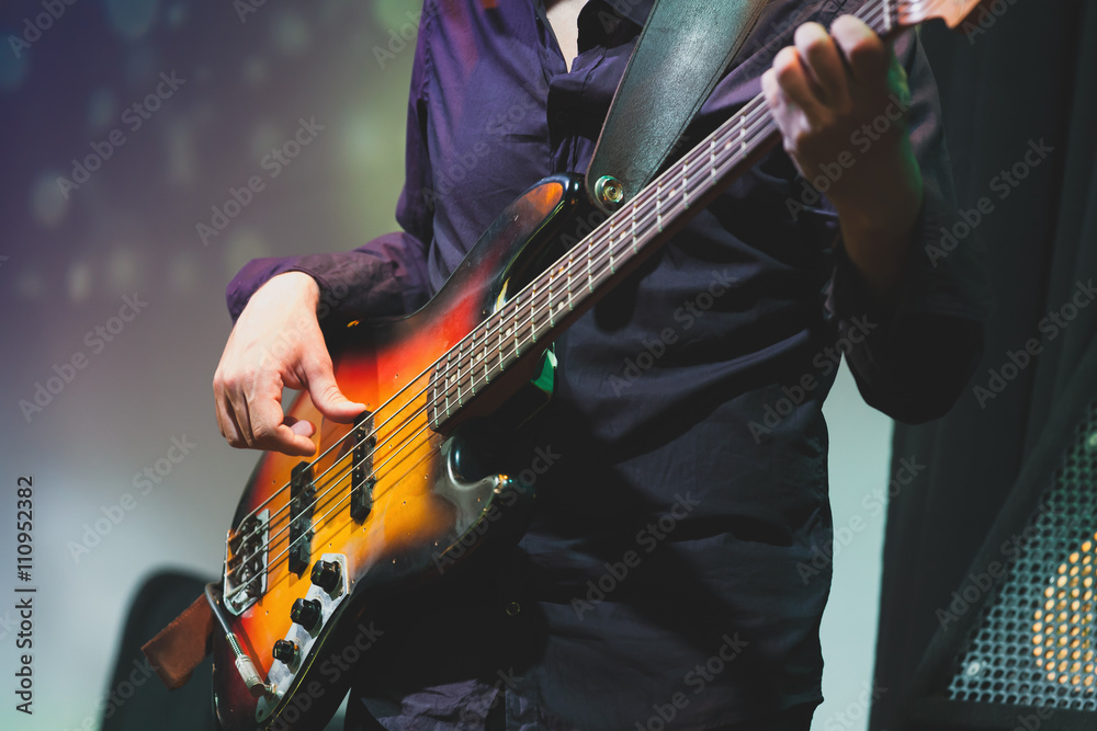 Obraz premium Rock and roll music, bass guitar player closeup