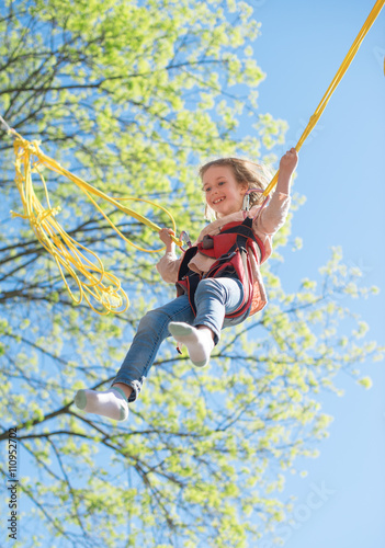 Photography Little girl on bungee trampoline with cords.