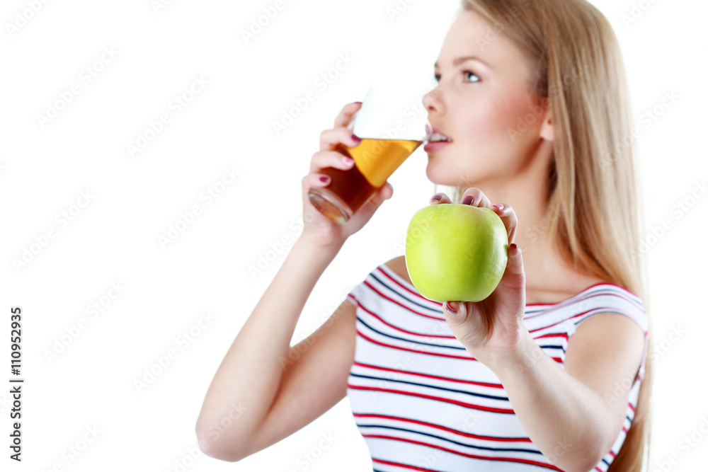 Young woman drinking a juice and holding apple Young woman drinking a juice and holding apple