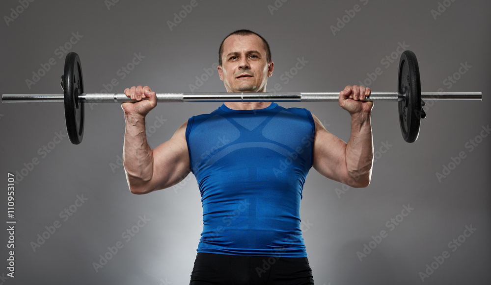 Man doing shoulder workout with barbell Man doing shoulder workout with barbell