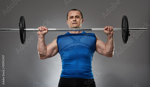 Man doing shoulder workout with barbell