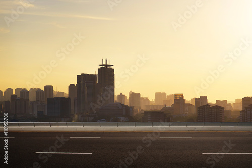 empty asphalt road and cityscape skyline,evening scene photo