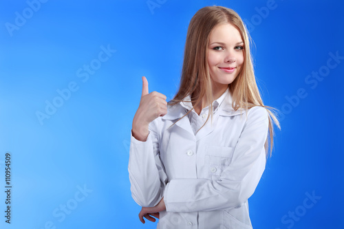 Beautiful caucaisn nurse or doctor showing ok gesture. Isolated photo