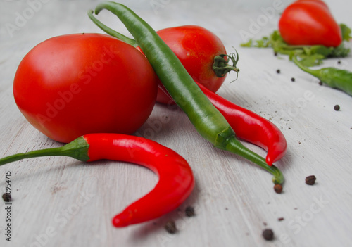 Seasonal green and red vegetables, tomatoes and chili peppers