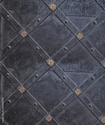 Vintage and ornamental metal door background. Decorated ancient texture with rhombs. 