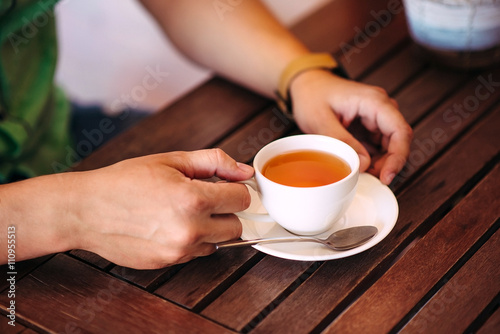 Close-up male hands holding a cup of tea