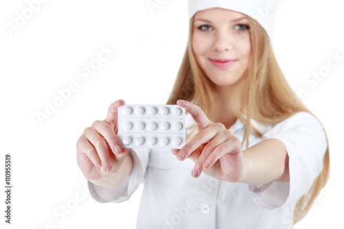 A beautiful young nurse offering pills