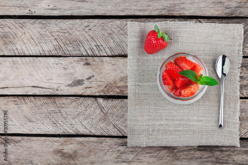 yogurt with strawberry on wooden background top view