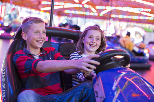 Brother and sister on fairground bumper cars
