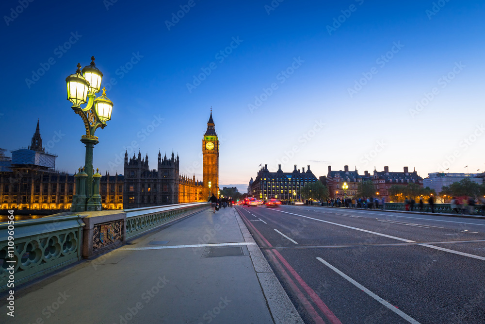 London scenery at Westminter bridge with Big Ben and blurred red bus, UK