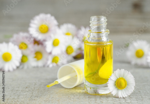 Small bottle of cosmetic chamomile oil for nail and cuticle care