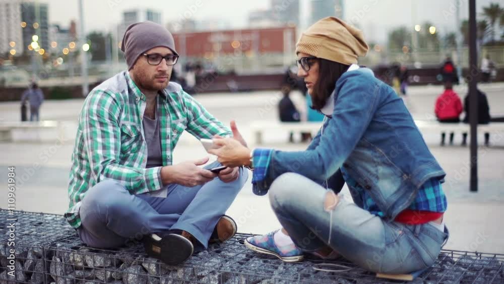 Woman showing something to her boyfriend on smartphone and looking worried
Woman showing something to her boyfriend on smartphone and looking worried