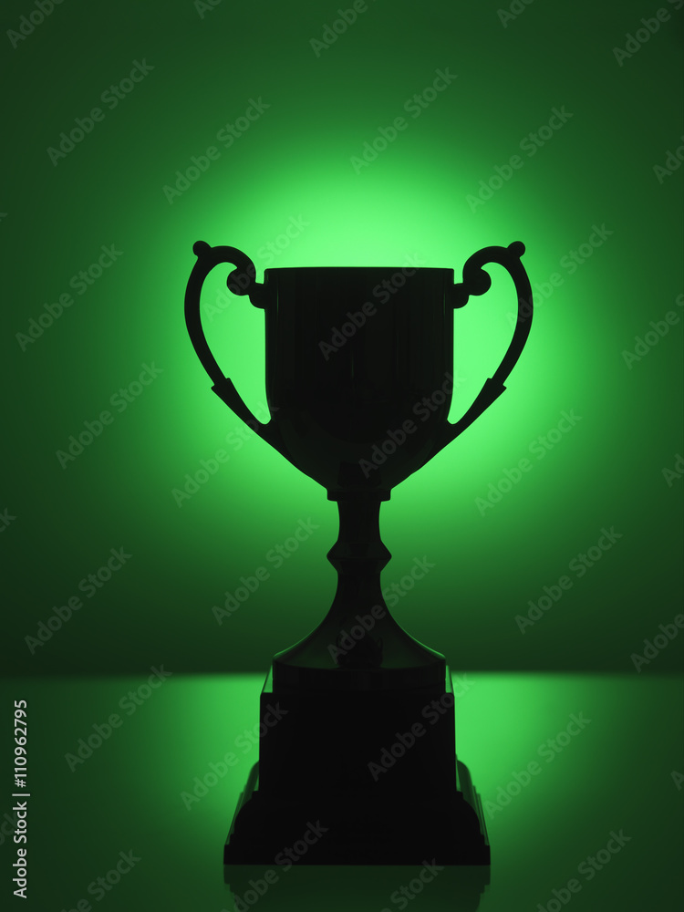 Silhouetted trophy with green background Stock Photo | Adobe Stock