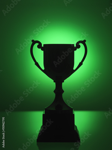 Silhouetted trophy with green background