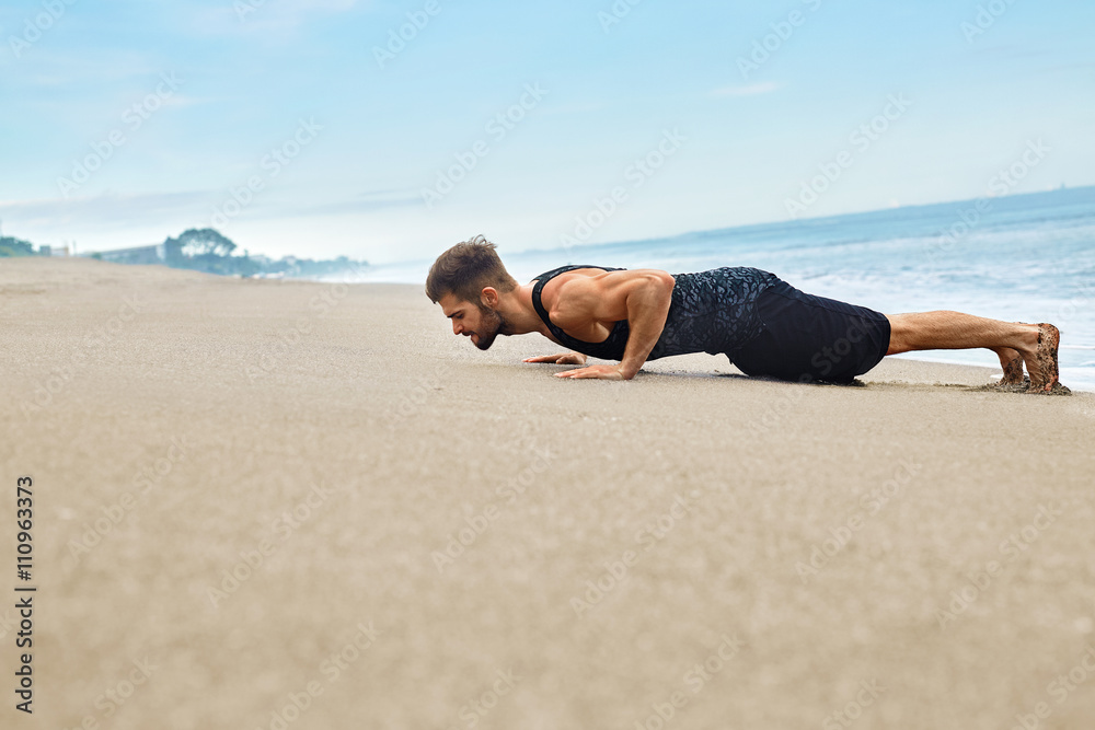 Fitness. Handsome Fit Athletic Man With Muscular Body Doing Push Ups Exercise On Wet Sand. Sporty Male Training And Exercising During Outdoor Workout At Beach. Sports, Healthy Active Lifestyle Concept