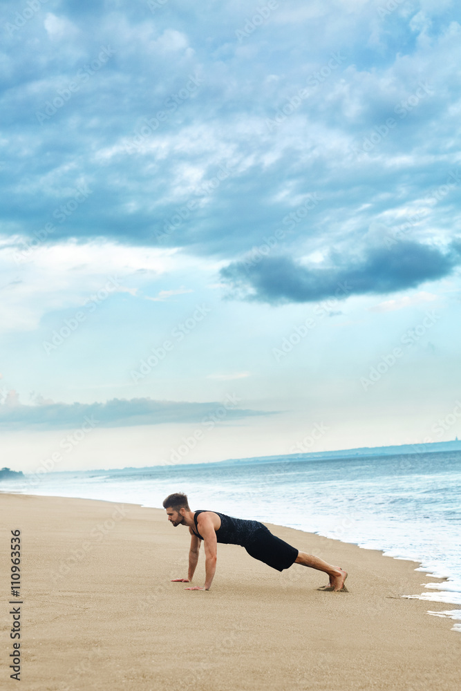 Sports. Sporty Handsome Male Doing Push Ups Exercise During Outdoor Workout At Beach. Fit Athletic Man With Muscular Body Exercising On Sand, Training Near Ocean. Fitness, Healthy Lifestyle Concept Sports. Sporty Handsome Male Doing Push Ups Exercise During Outdoor Workout At Beach. Fit Athletic Man With Muscular Body Exercising On Sand, Training Near Ocean. Fitness, Healthy Lifestyle Concept