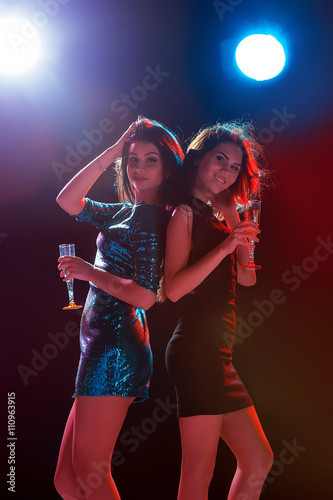 Two beautiful girls dancing at the party