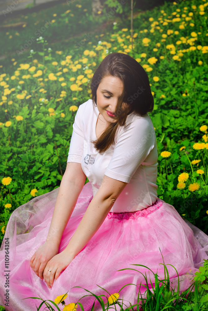 Beautiful sexy young hipster girl outdoors.Posh woman with long brunette hair evening makeup wearing light fluffy pink rosy skirt and vans sneakers posing outdoors in the city urban style in summer Beautiful sexy young hipster girl outdoors.Posh woman with long brunette hair evening makeup wearing light fluffy pink rosy skirt and vans sneakers posing outdoors in the city urban style in summer