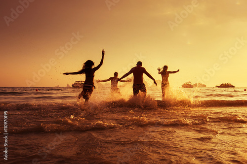 Group of young friends having fun on the beach