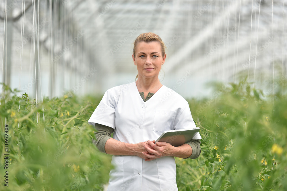 Portrait of agronomist standing in greenhouse Portrait of agronomist standing in greenhouse