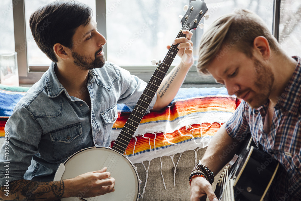 Male couple at home, play guitar and banjo Stock Photo | Adobe Stock