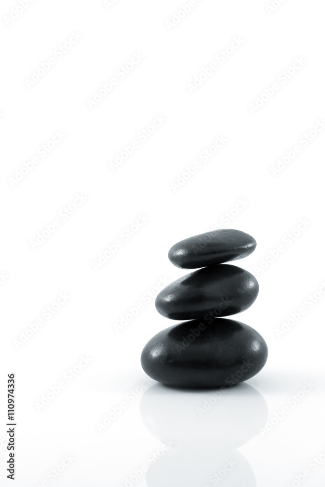 Stack of black pebbles on white background Stack of black pebbles on white background