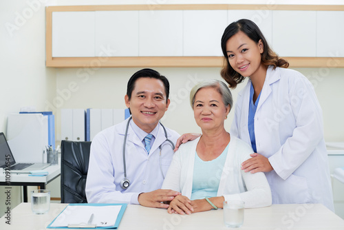 Vietnamese doctors and their senior patient in clinic