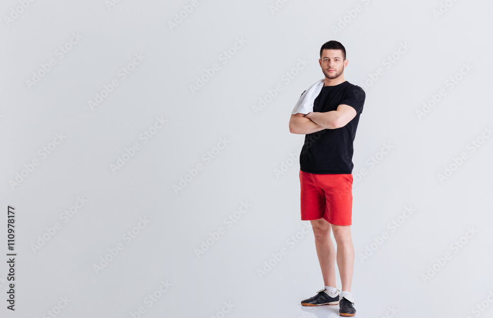 Fitness man standing with arms folded Fitness man standing with arms folded