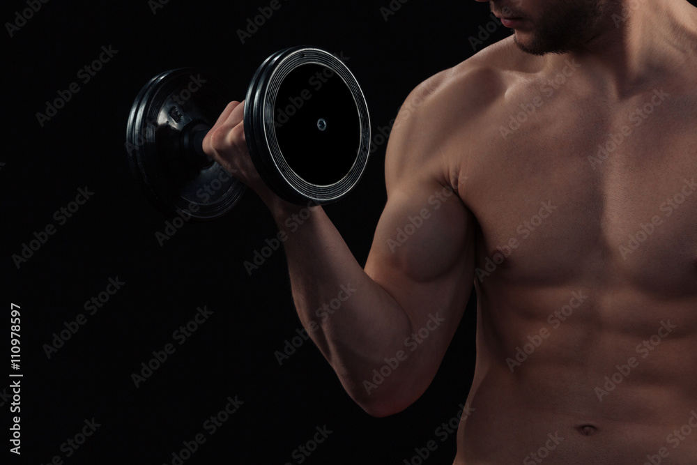 Muscular man workout with dumbbell