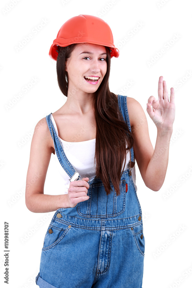 Portrait of young female builder in overalls and helmet ,ok,on w