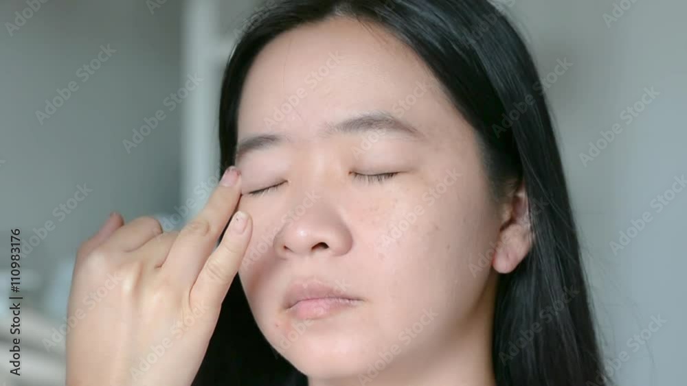 Woman is doing facial cosmetic makeup using eyebrow brush and cream to a model in HD quality Woman is doing facial cosmetic makeup using eyebrow brush and cream to a model in HD quality