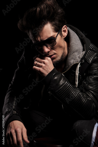 dramatic thinker in leather jacket and sunglasses