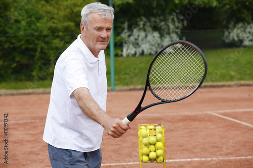 Elderly tennis coach © sepy