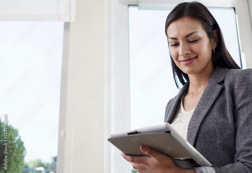 Young businesswoman woman using digital tablet in office Young businesswoman woman using digital tablet in office