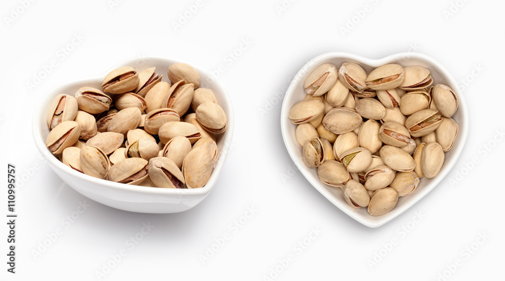 Pistachio in a heart shaped bowl, isolated on white Pistachio in a heart shaped bowl, isolated on white
