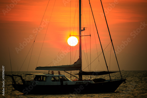 beautiful natural scenic of sun set behind sailing boat