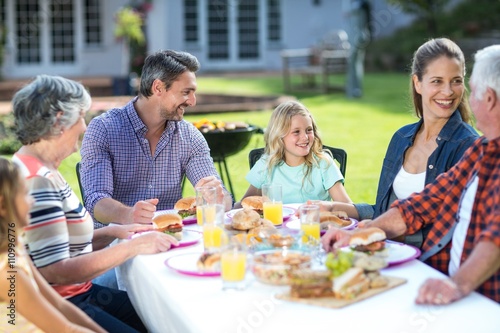 Happy multi-generation family sitting at table © WavebreakmediaMicro