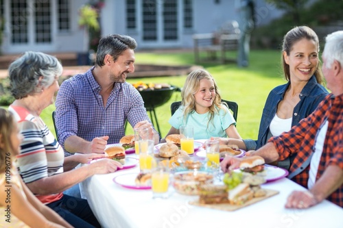 Happy multi-generation family sitting at table