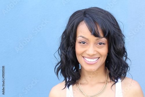 Laughing African American woman with an wavy hairstyle and good sense of humor smiling 