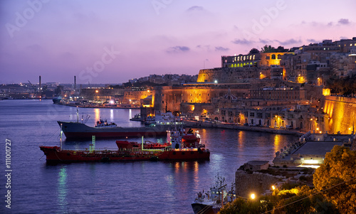 The night view of Grand Harbour with the cargo ships moored near