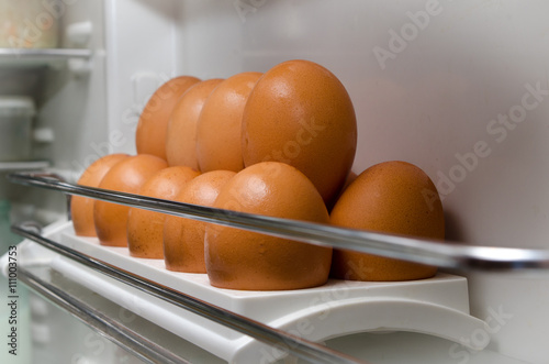 eggs in refrigerator / brown eggs in a tray in the refrigerator