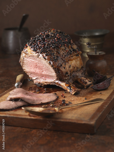 Christmas dinner. Bone in sirloin joint with peppercorn crust and brandy glaze served with roasted potatoes