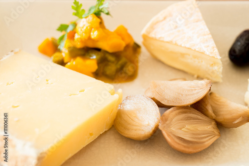 Slices of Cheese Alongside Shallots and Vegetable Side Dish